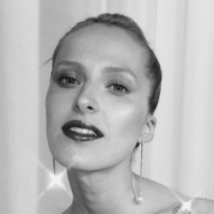 Anais Kostinou Elongate Rose Feather Earrings on model